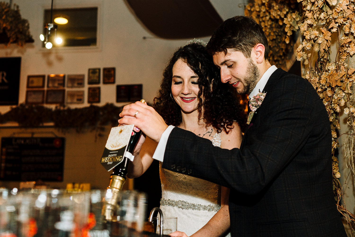 Bride and groom pulling a pint at Lancaster Brewery