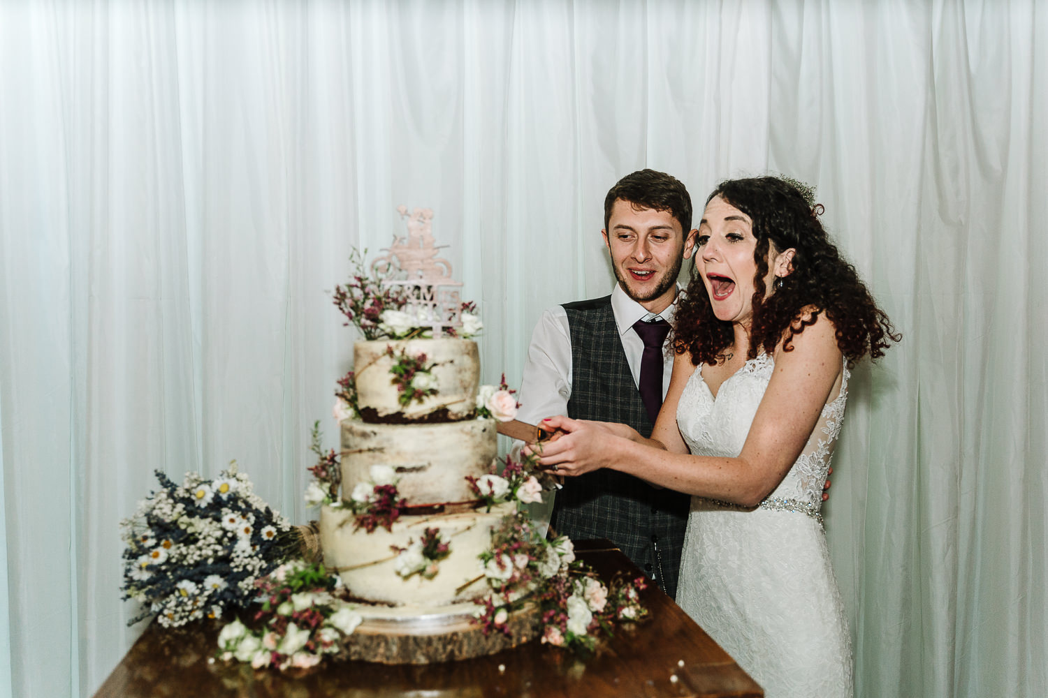Bride and groom cutting the cake at Lancaster Brewery