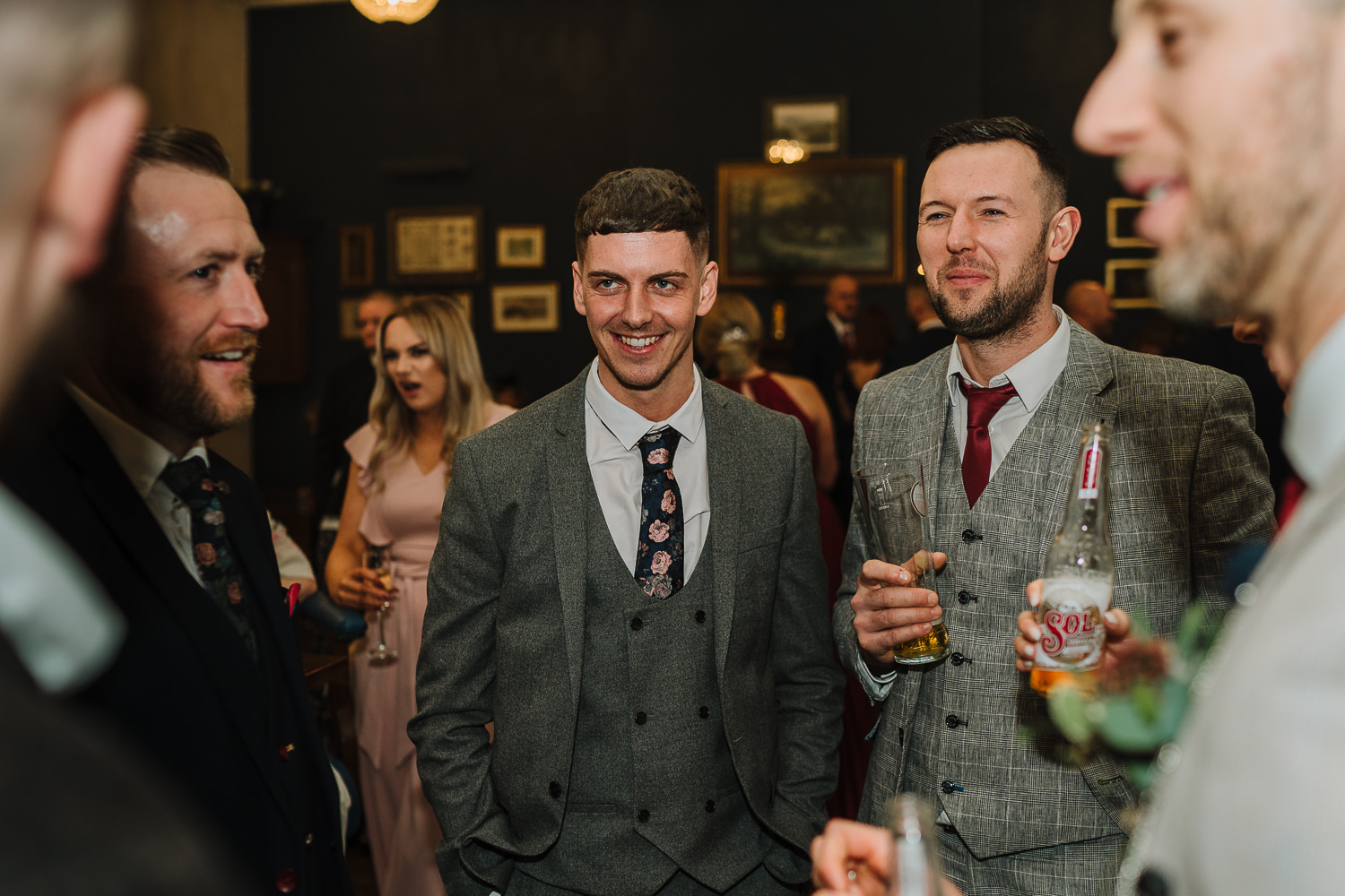 male guests laughing with the groom