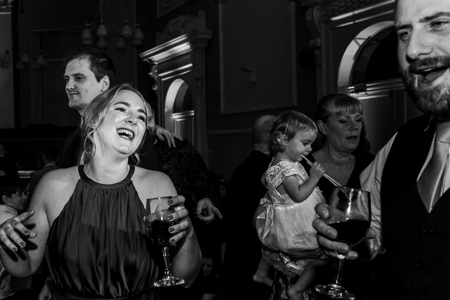 Bridesmaid dancing with male guest laughing