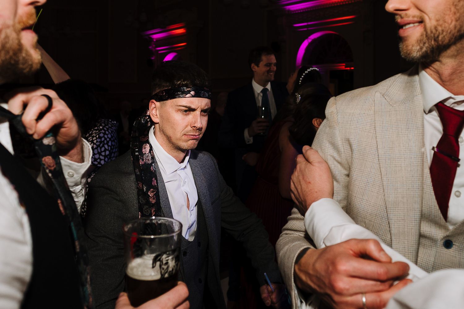 Male guest dancing with his tie around his head