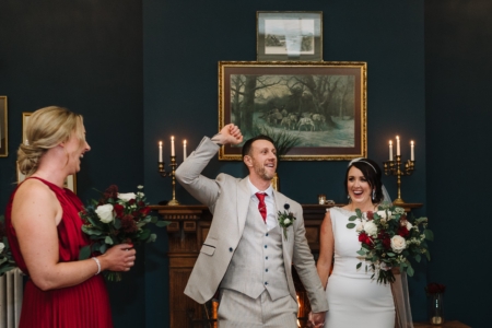 bride and groom dancing down the aisle at the courthouse
