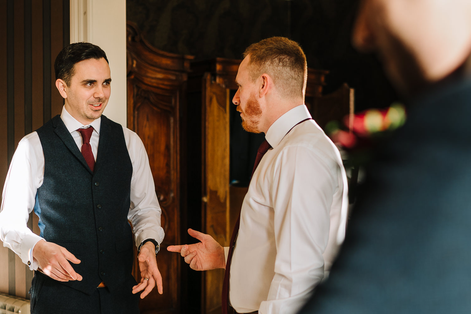 Groomsmen chatting in the bridal suite of Eaves Hall