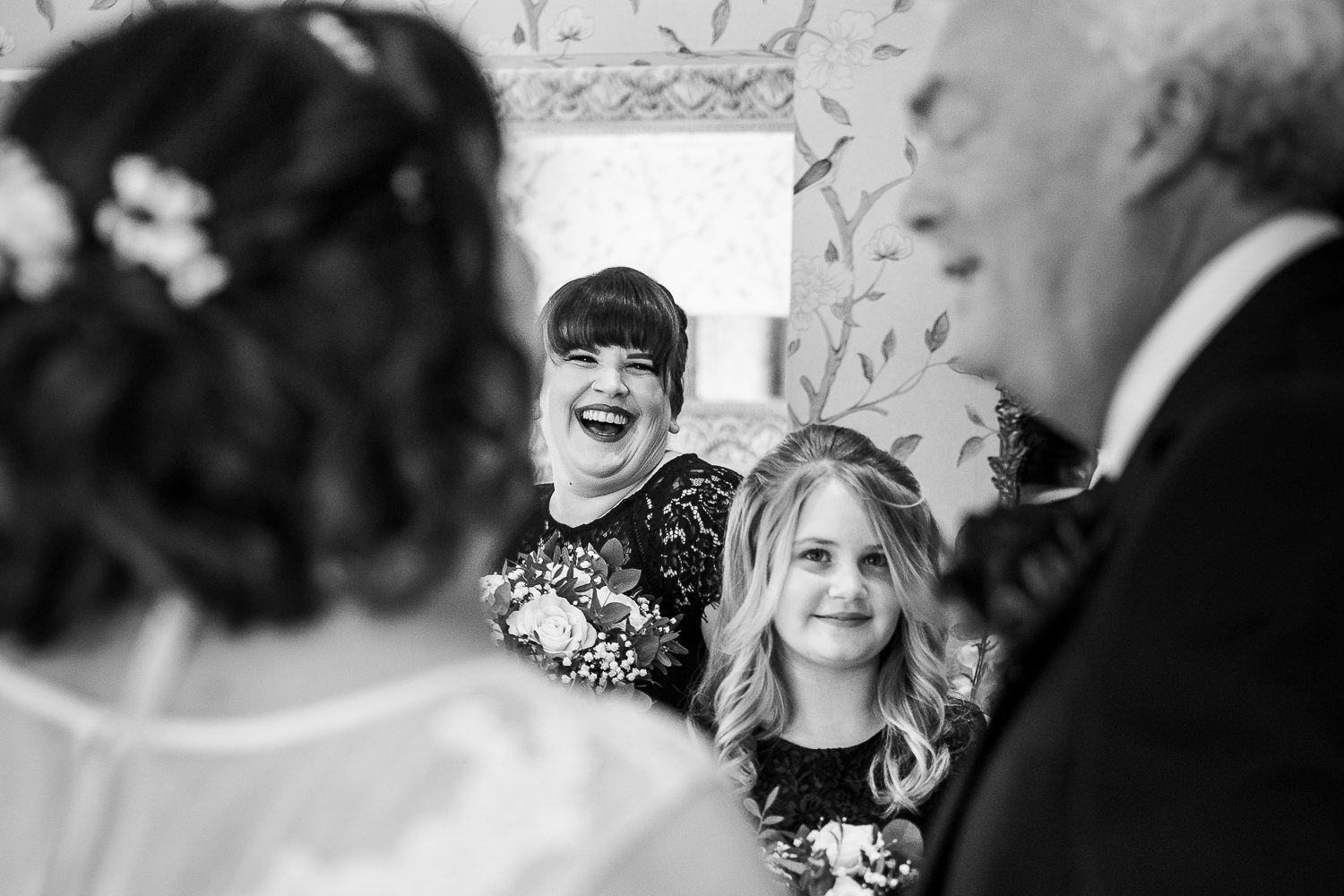 Bride and bridesmaid laughing