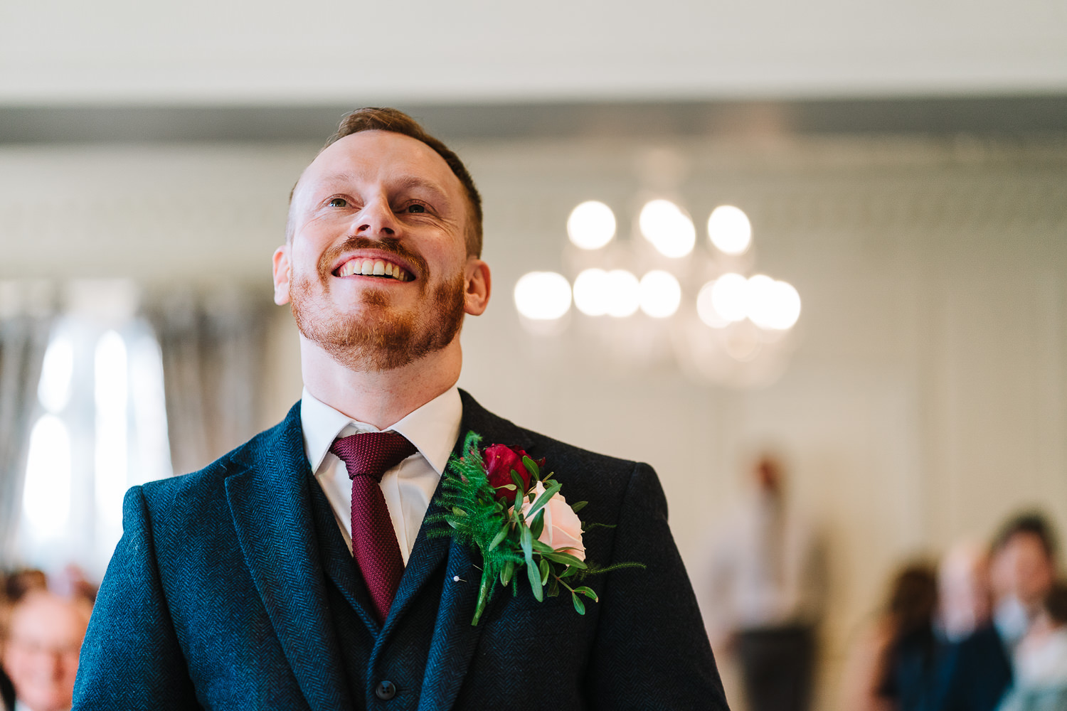 Groom smiling before the bride walks down the aisle at Eaves Hall