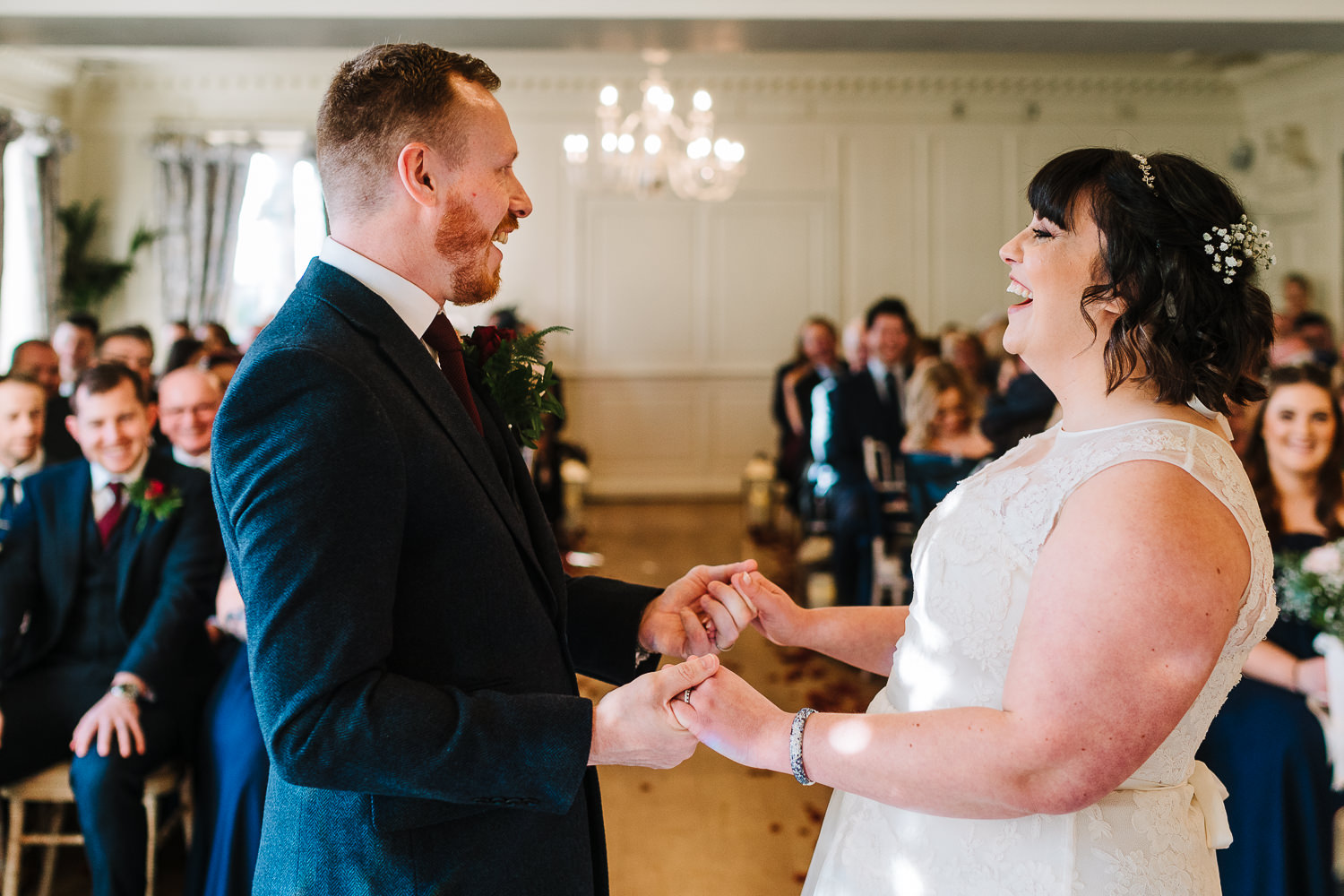 Bride and groom laughing at Eaves Hall