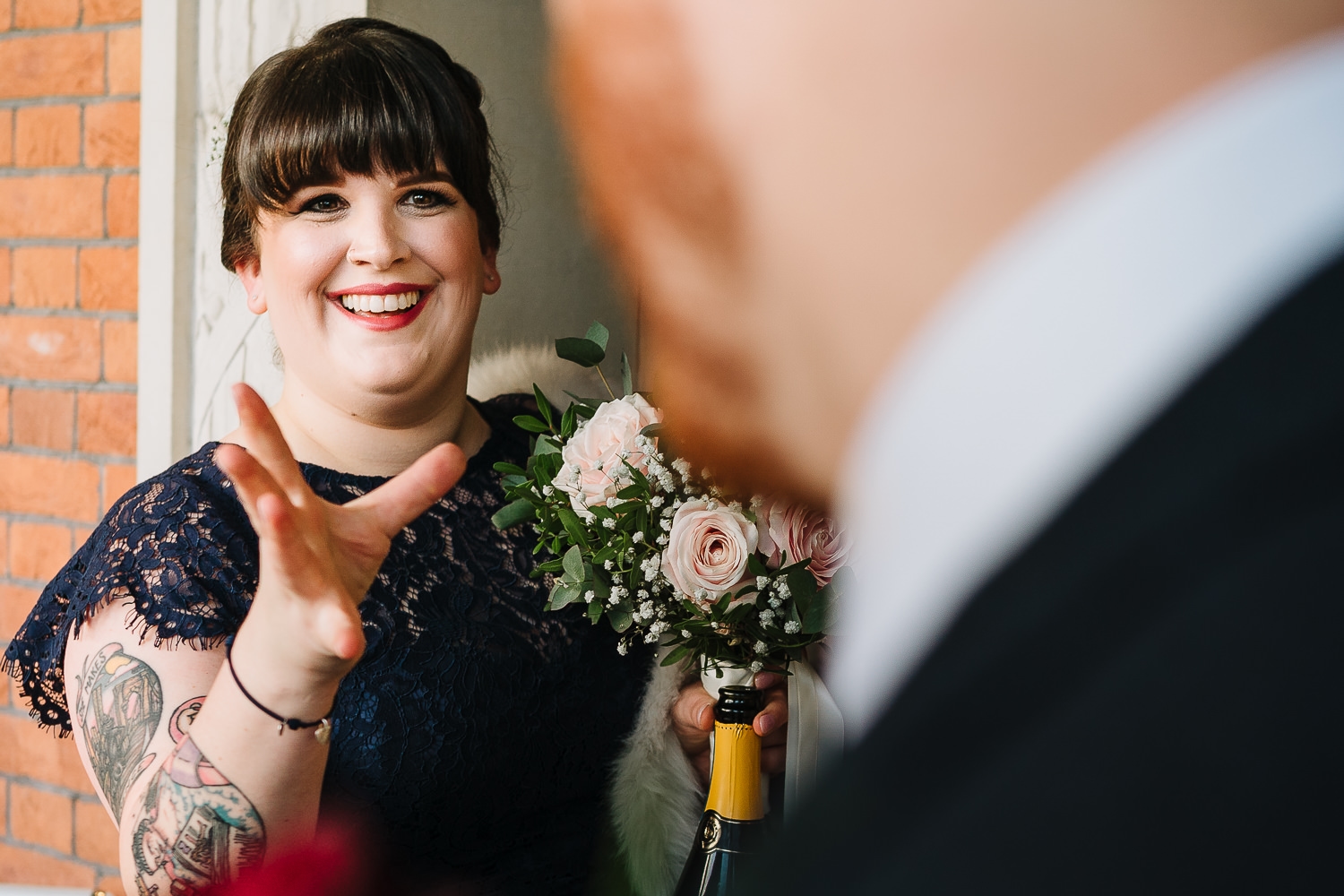 Bridesmaid laughing with groom