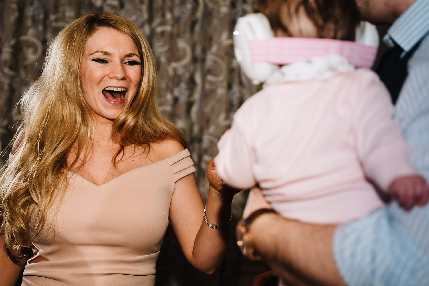 Female guest dancing with her baby
