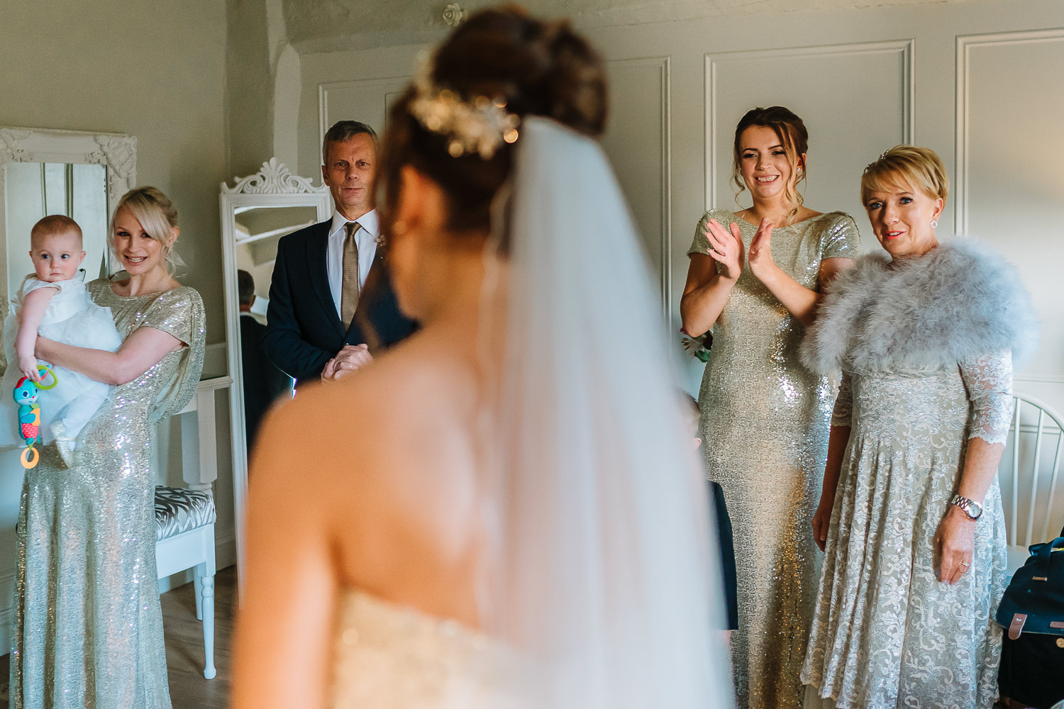 Bride seeing her dad and bridesmaids for the first time