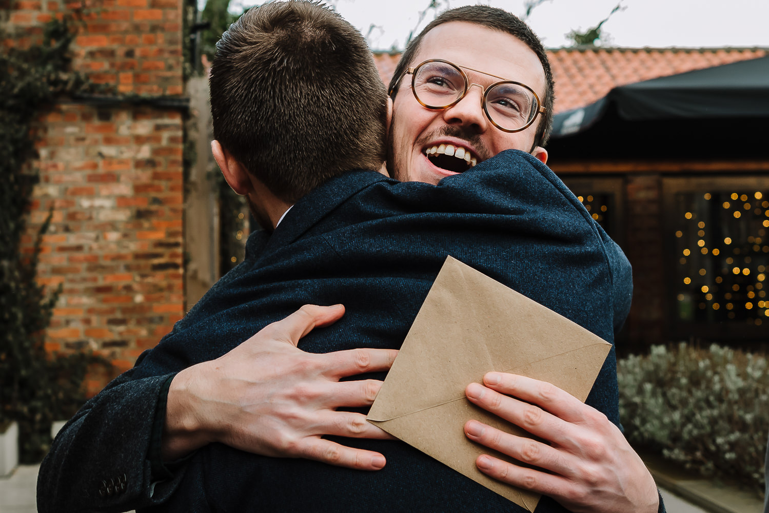 Groom hugging a male guest