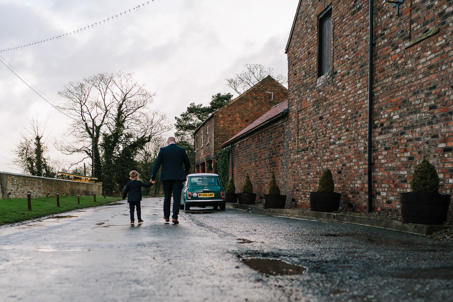 father of bride walking with grandson