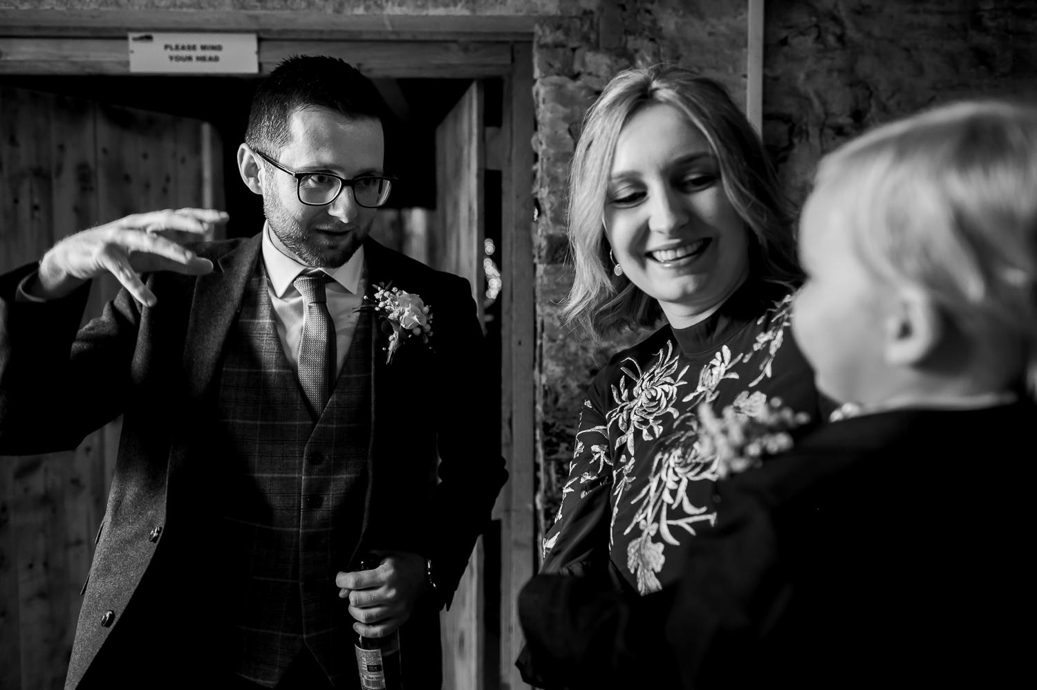 Groom playing with a child at the normans wedding venue