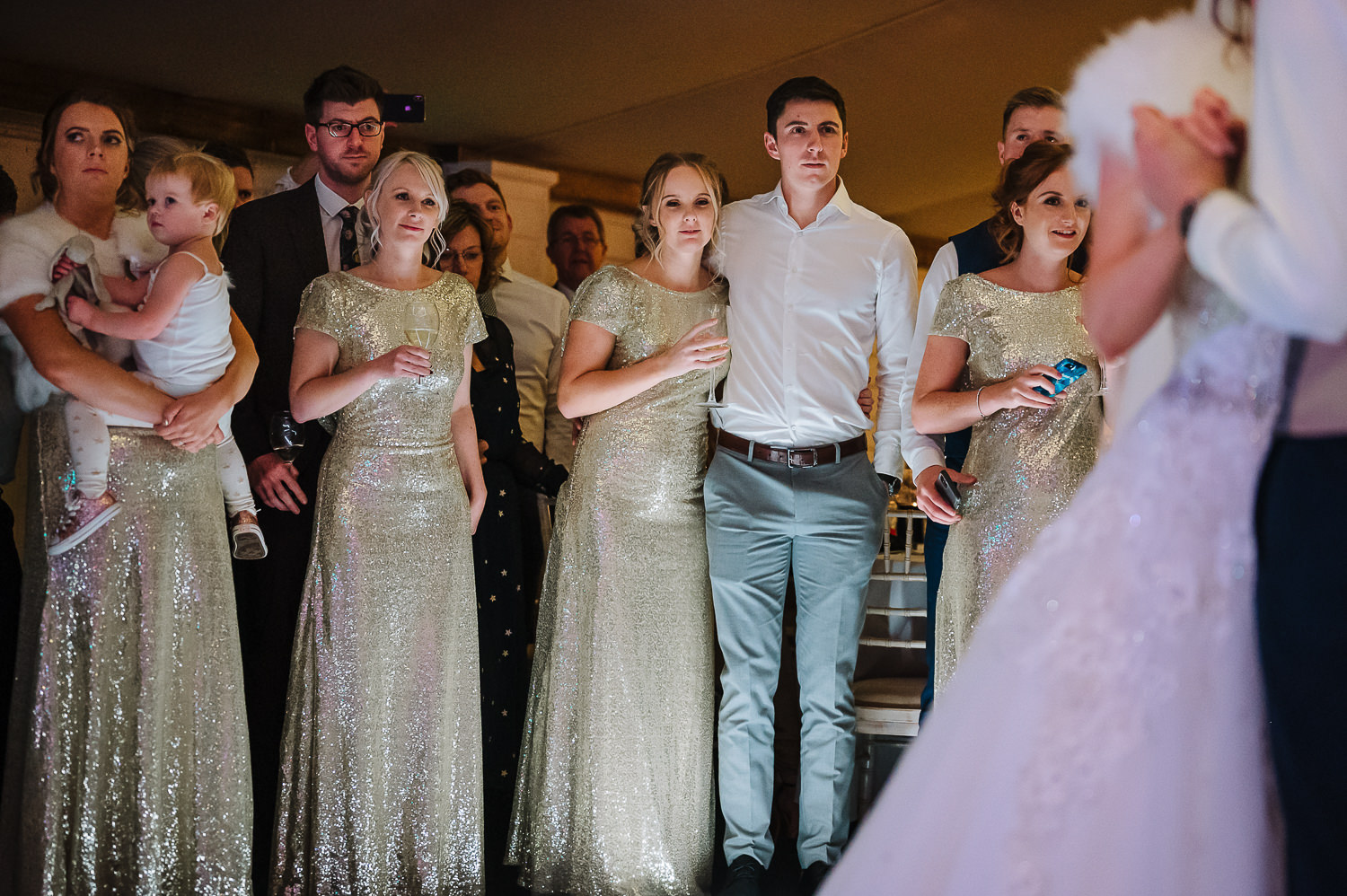 bridesmaids looking on to the first dance