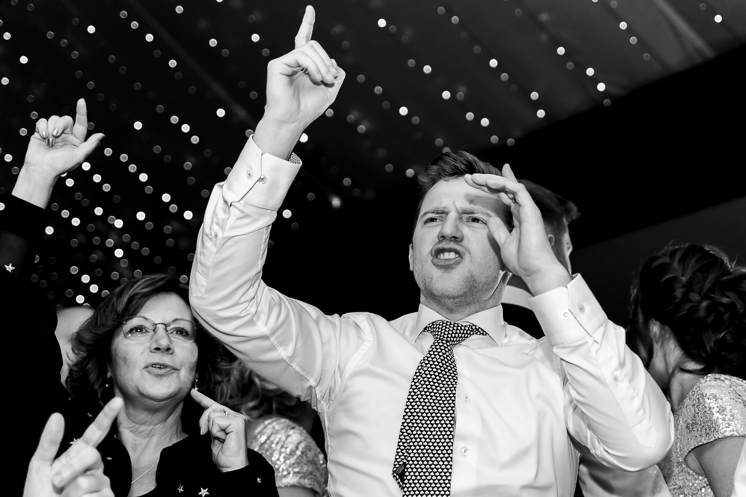 guest dancing with his arms in the air