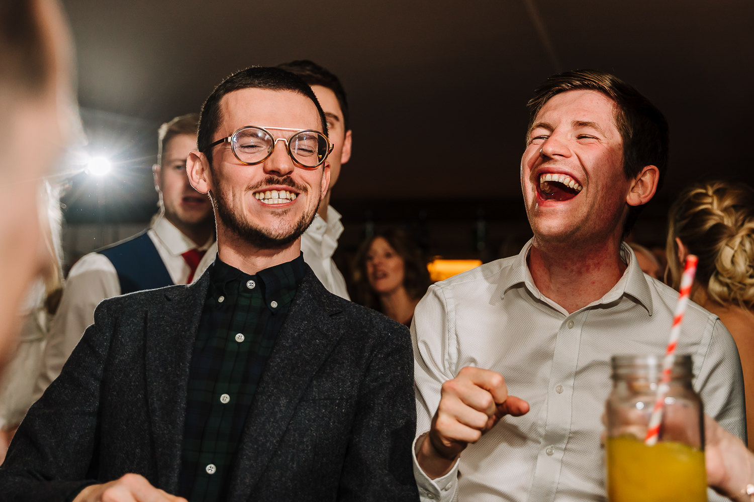 Male guests dancing and laughing
