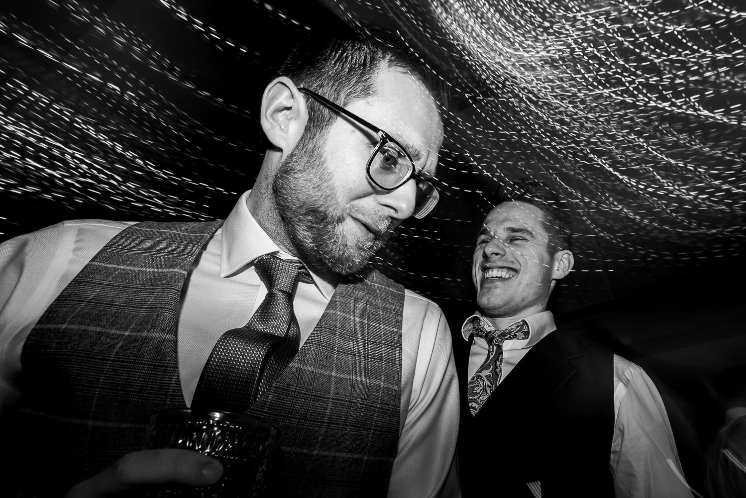 Groom dancing with male guest