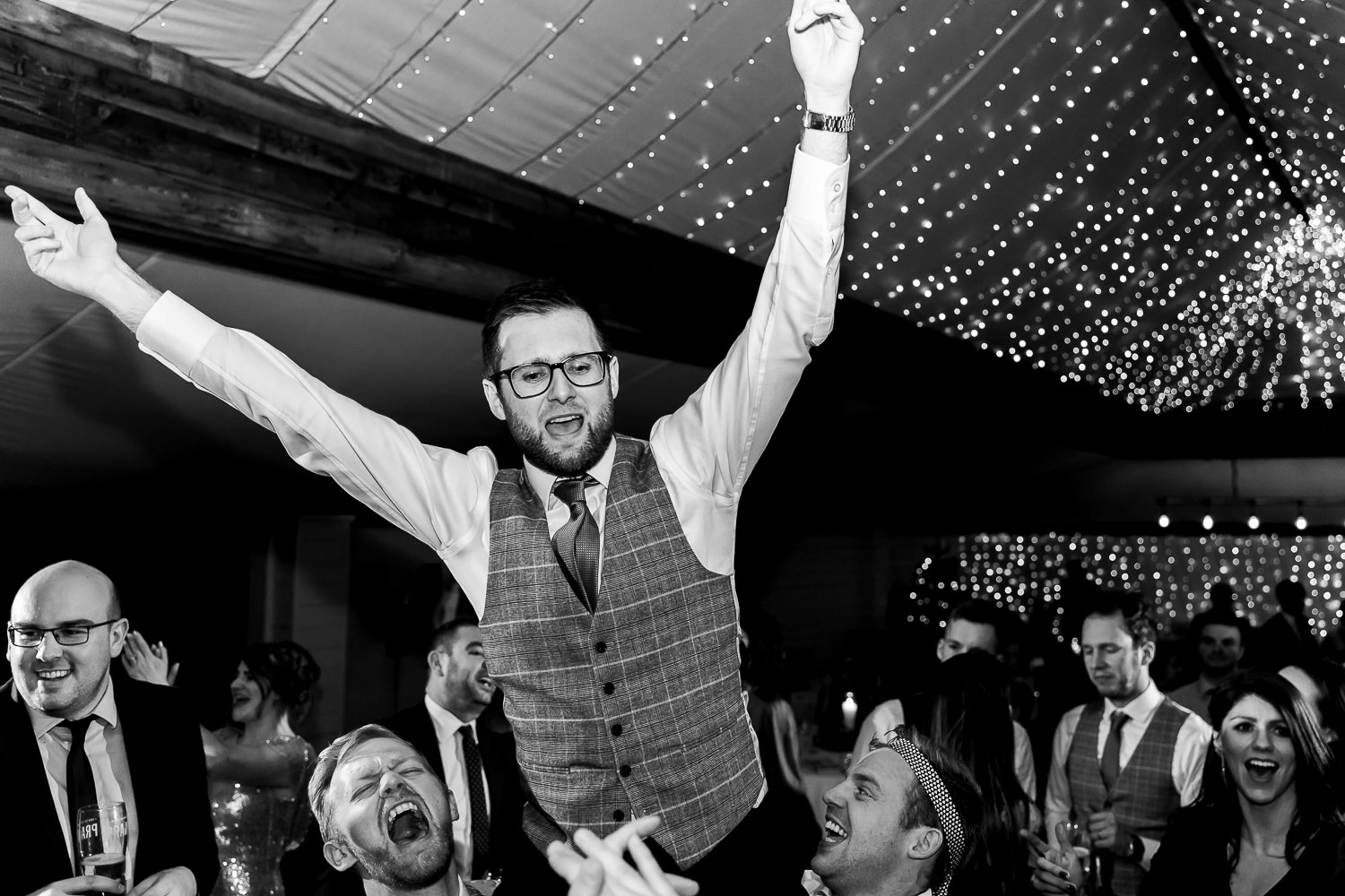 Groom being picked up on the dance floor