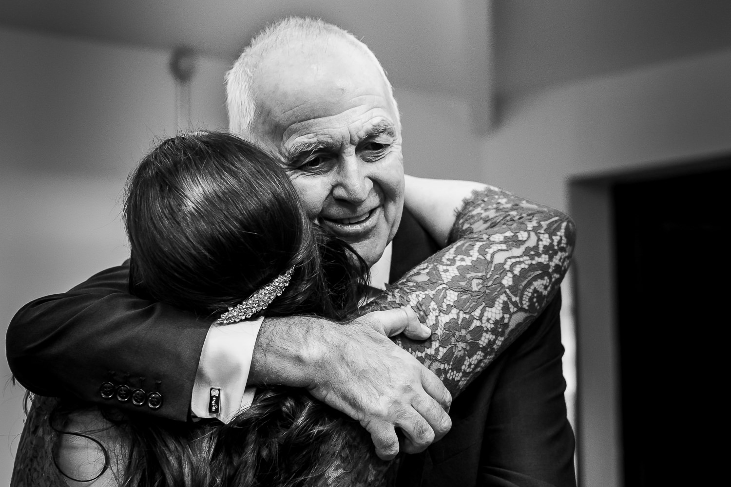 Father of the bride hugging the bride