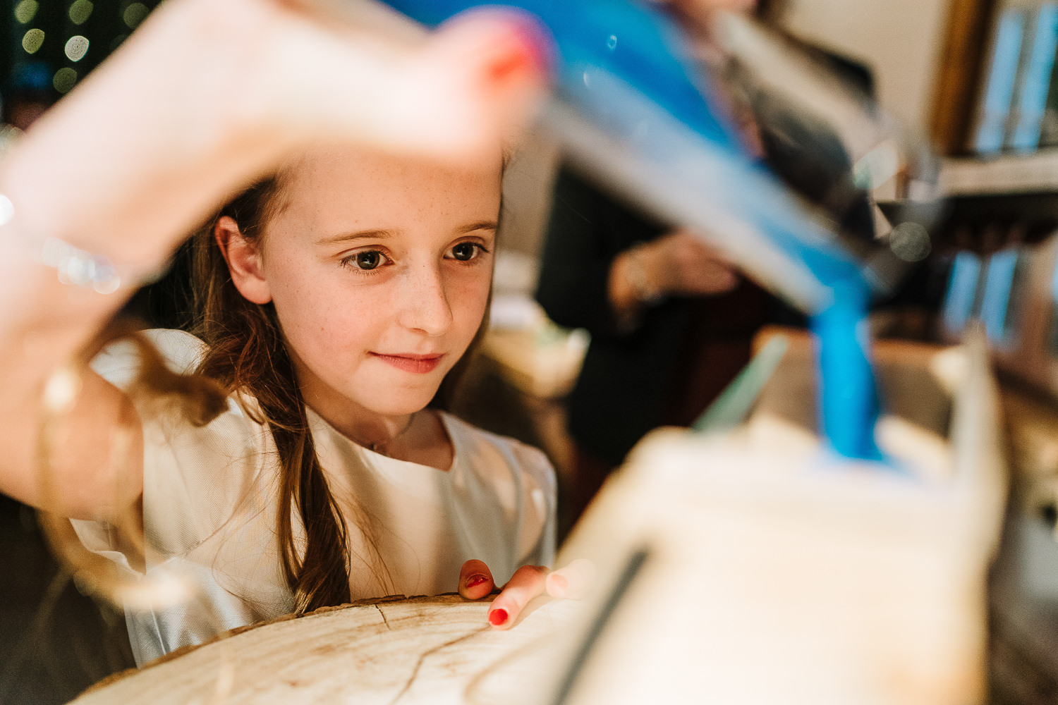 Flower girl filling up the sand