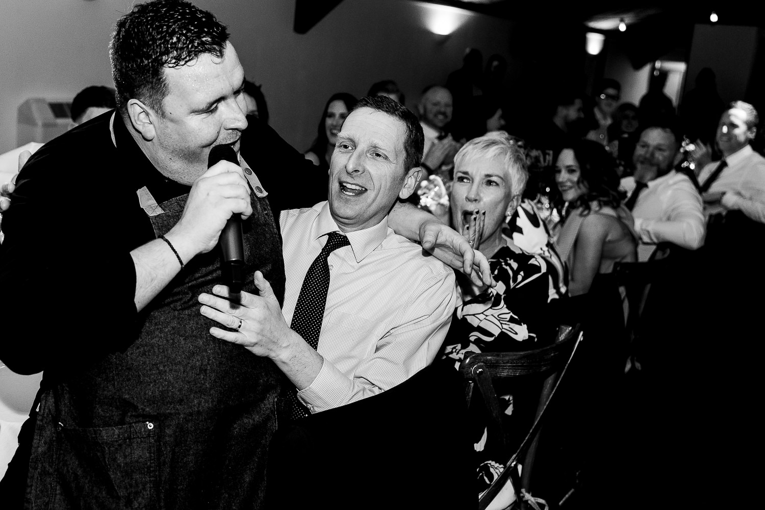 Singing waiter sitting on guests knee