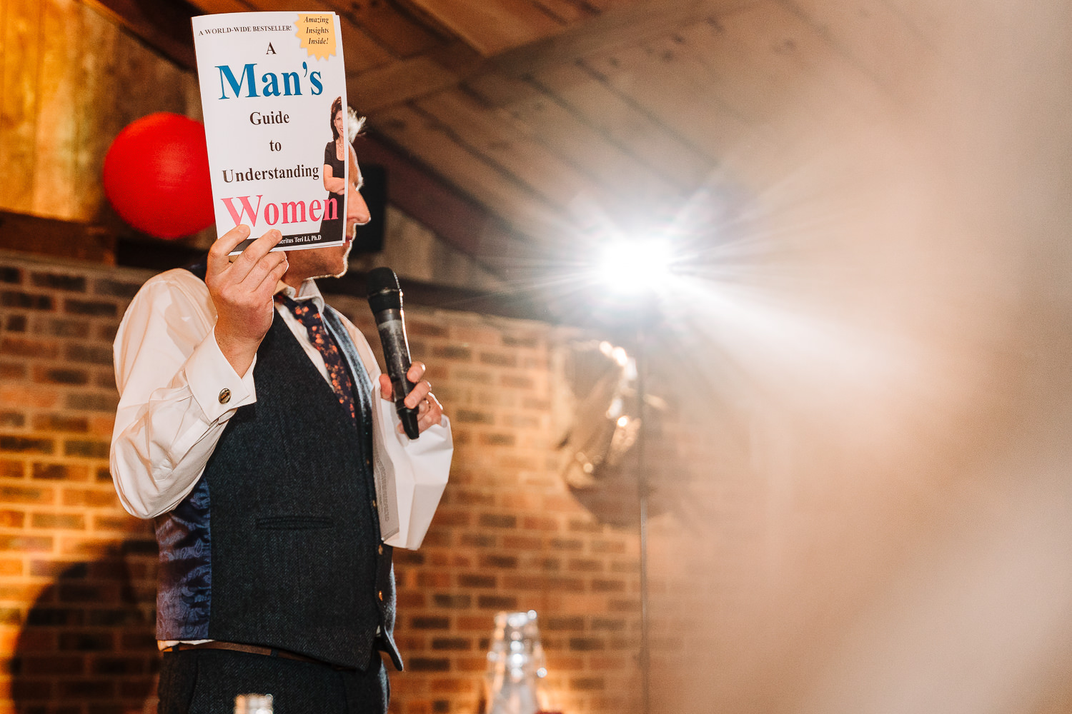 Groom holding up a prop