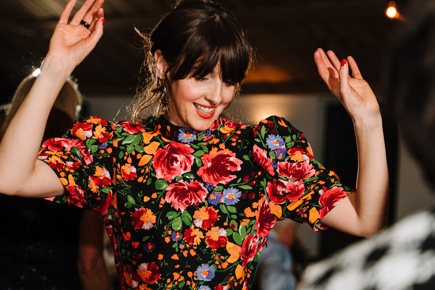 female guest dancing with hands in the air