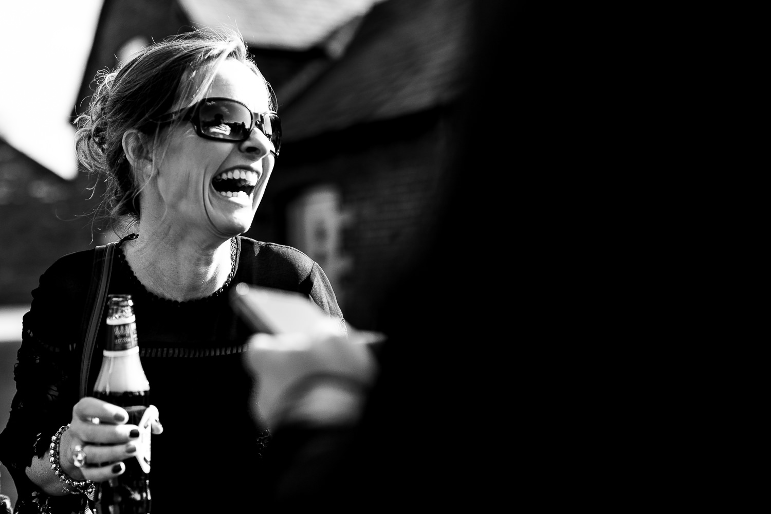 Sandhole Oak Barn Wedding Photography 43 wedding guest laughing