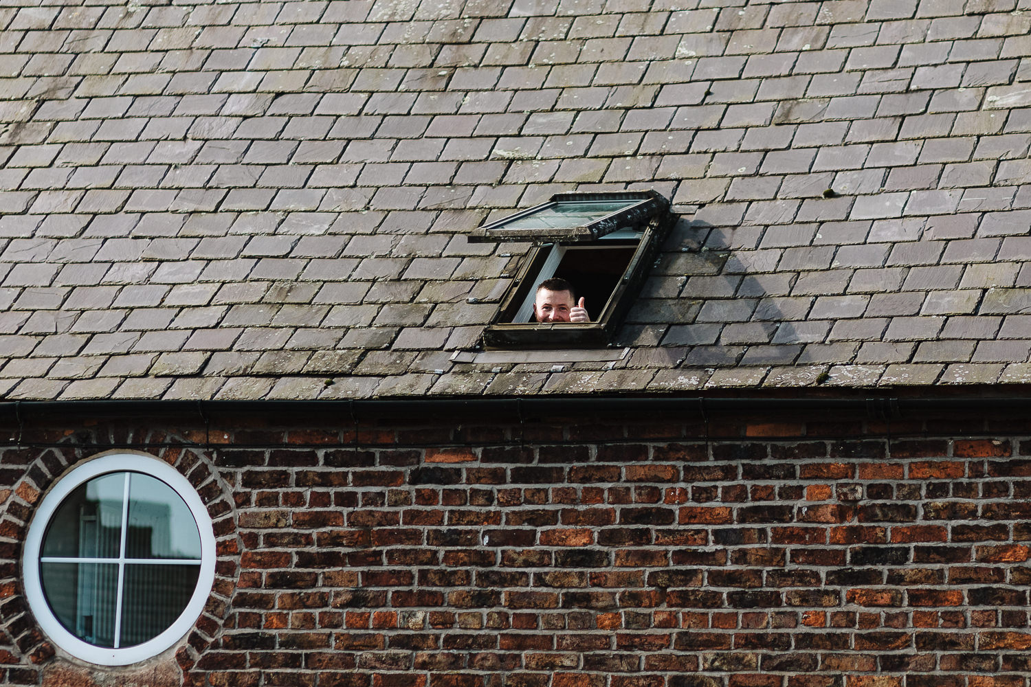Sandhole Oak Barn Wedding Photography 6 Wedding guest looking out the window