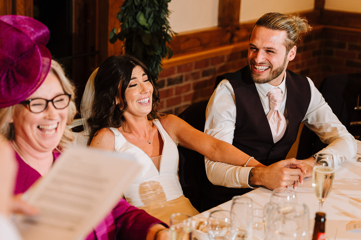 Sandhole Oak Barn Wedding Photography 67 bride and groom laughing at top table
