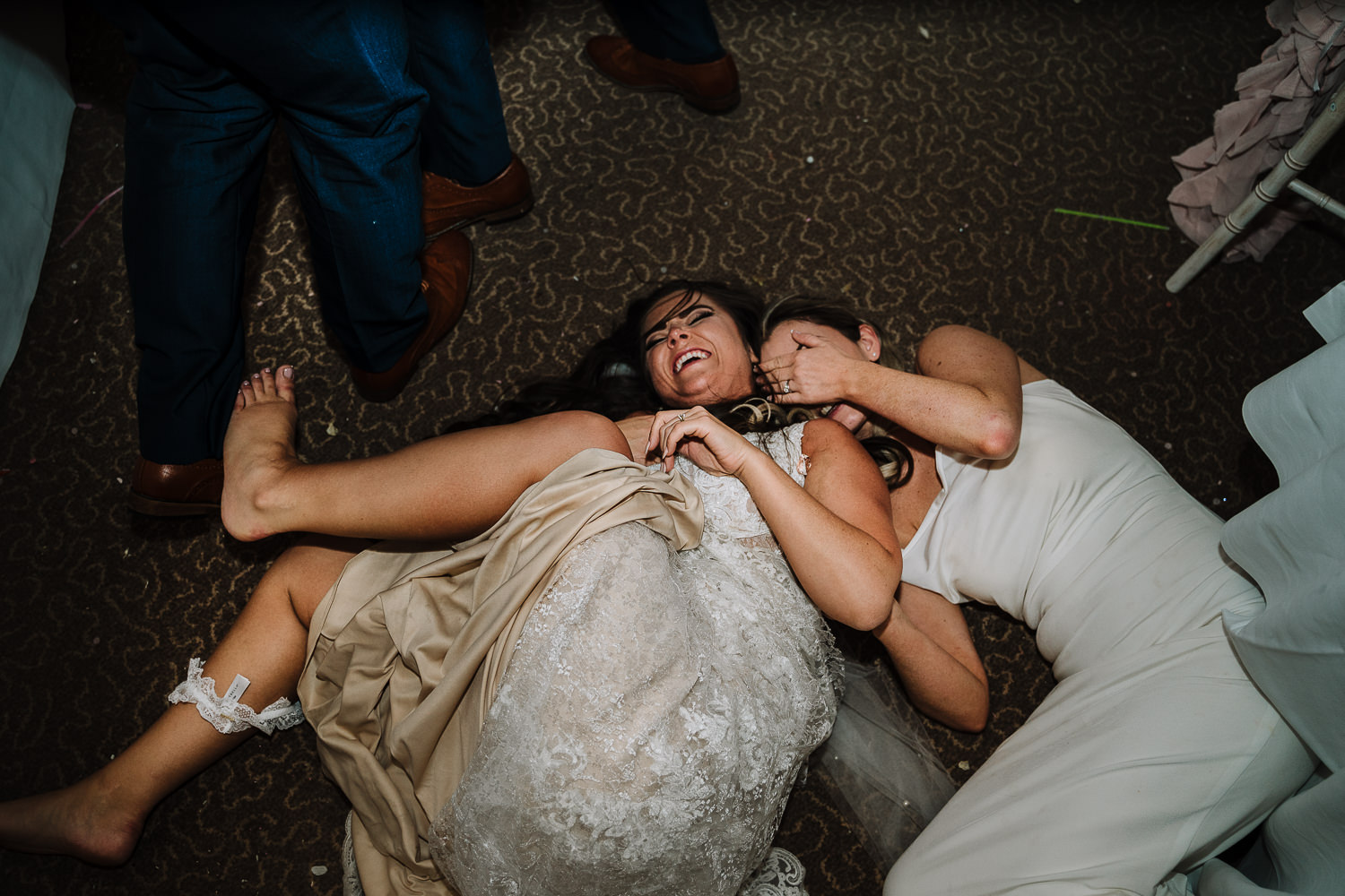 Bride and bridesmaid fallen on the floor at Gretna Green