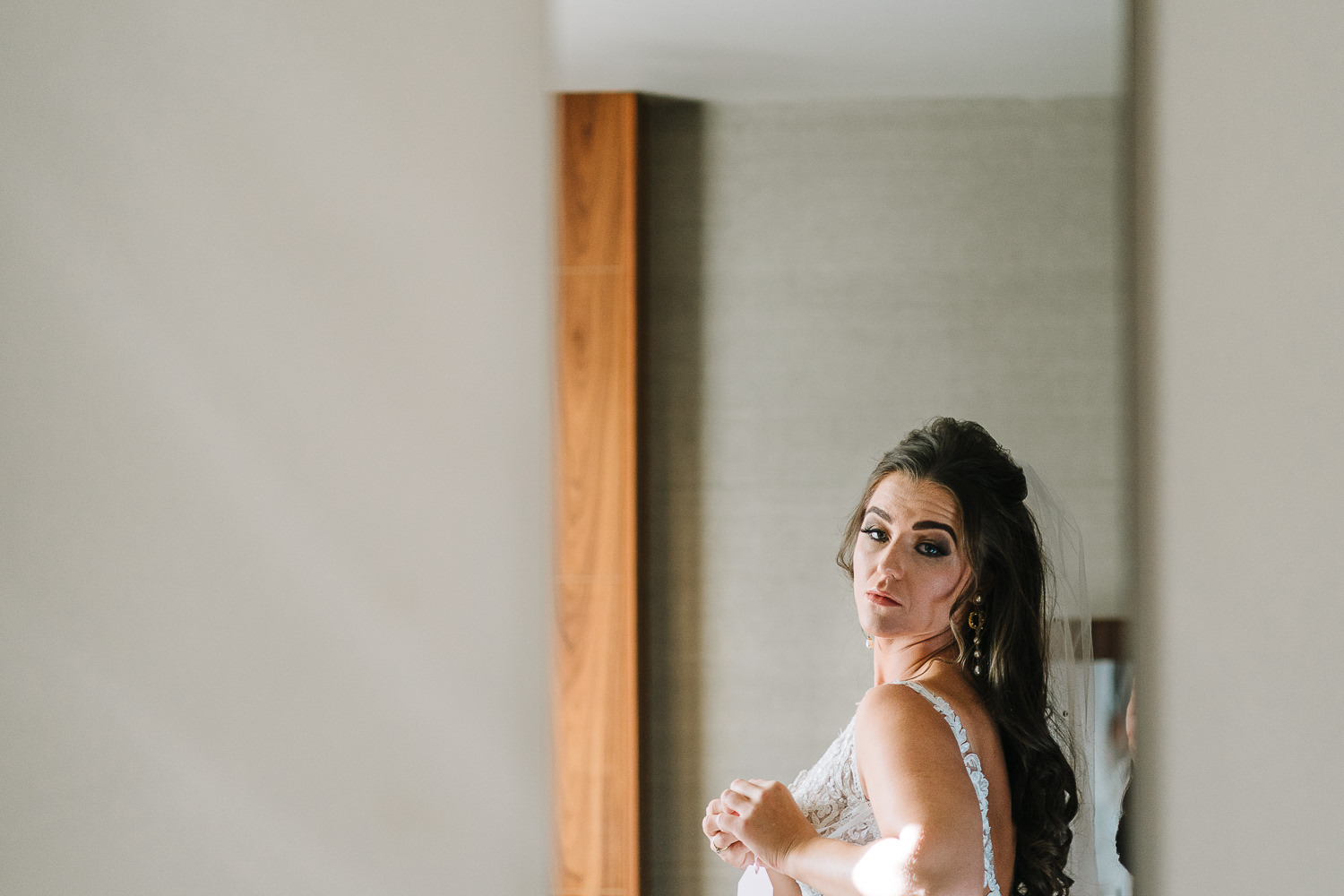Bride looking in mirror