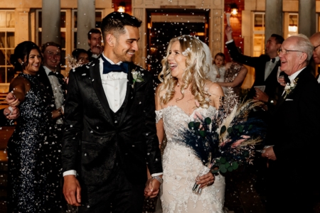 The couple laughing with confetti