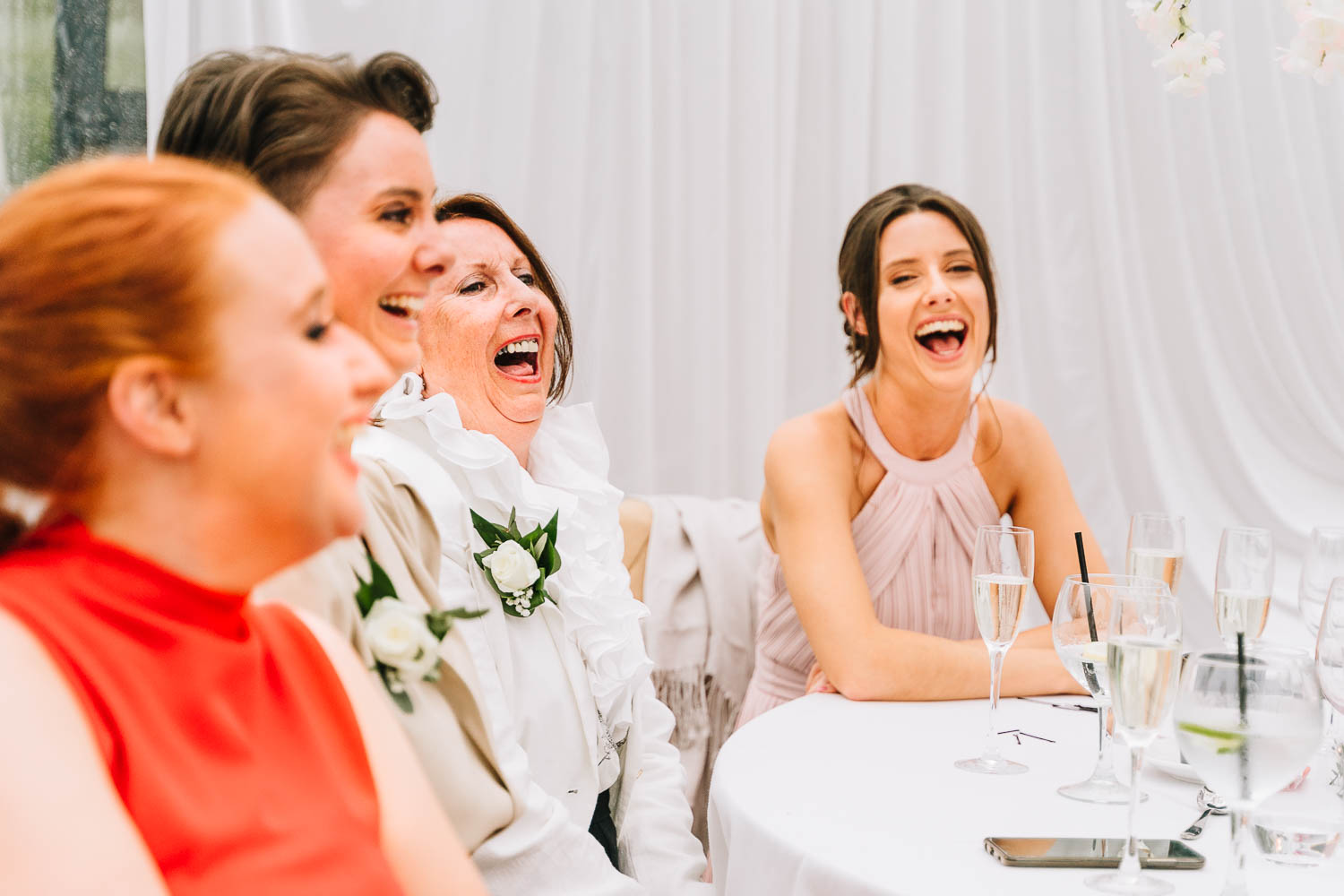wedding guests laughing during speeches