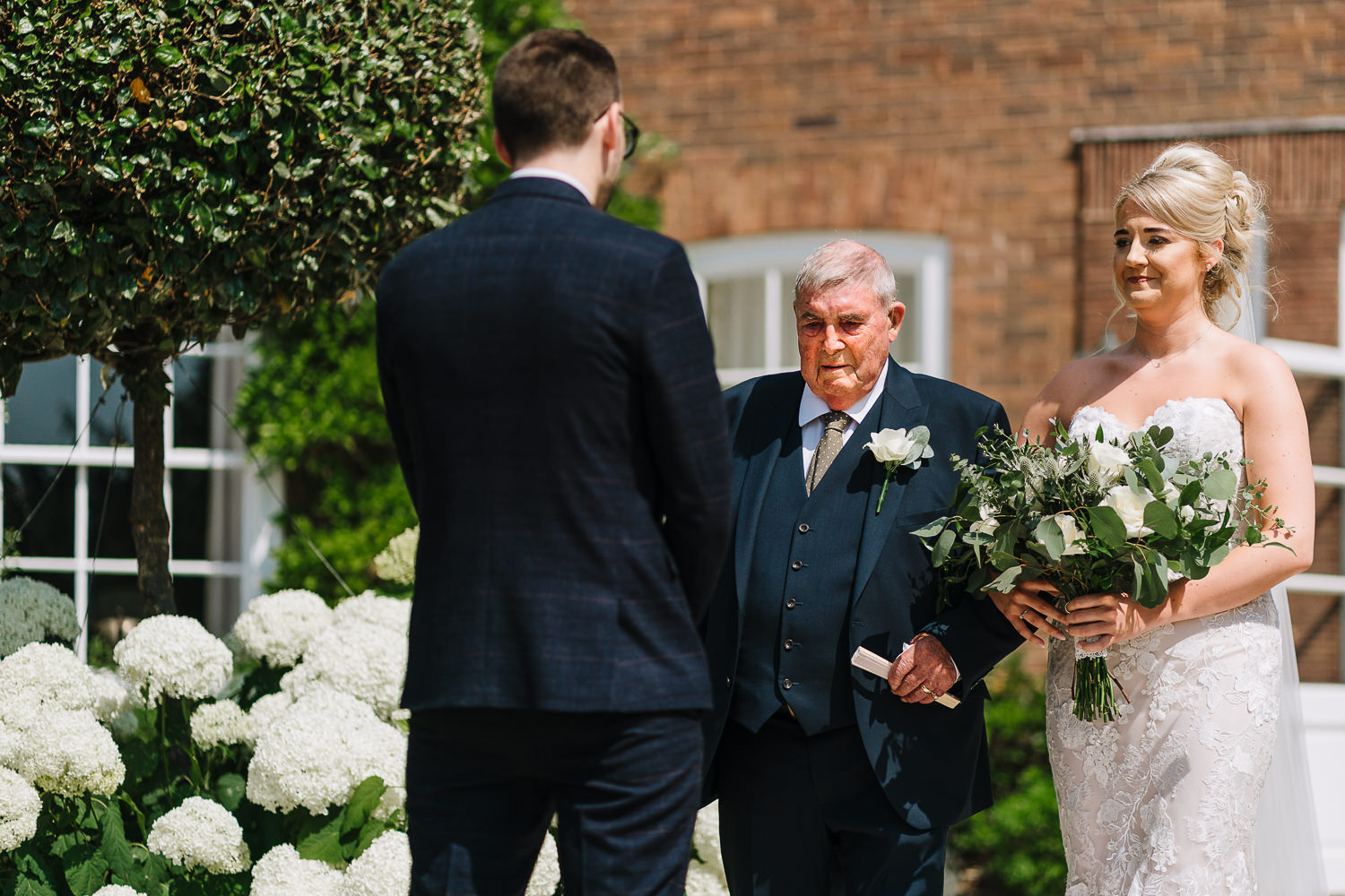 Bride walking down the aisle with grandad
