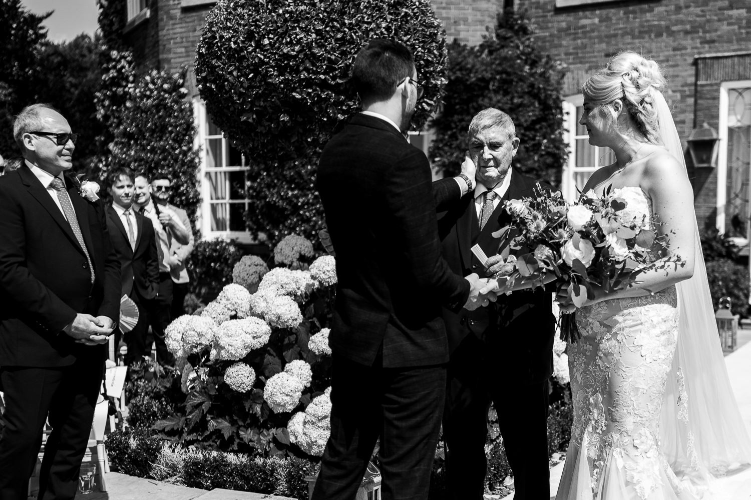 Groom touching grandads face at Delamere Manor