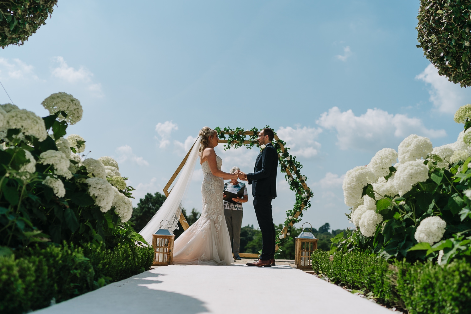 A photo of the bride and groom during the service
