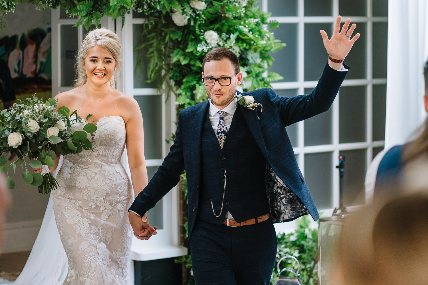 Bride and groom walking into the room