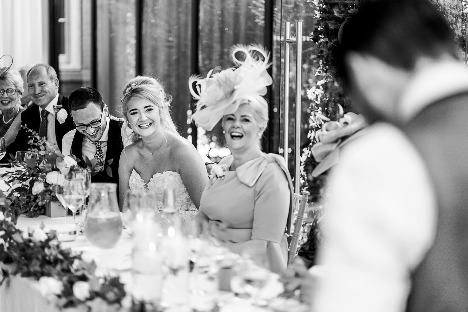 Best man speech and bridal party laughing in the background