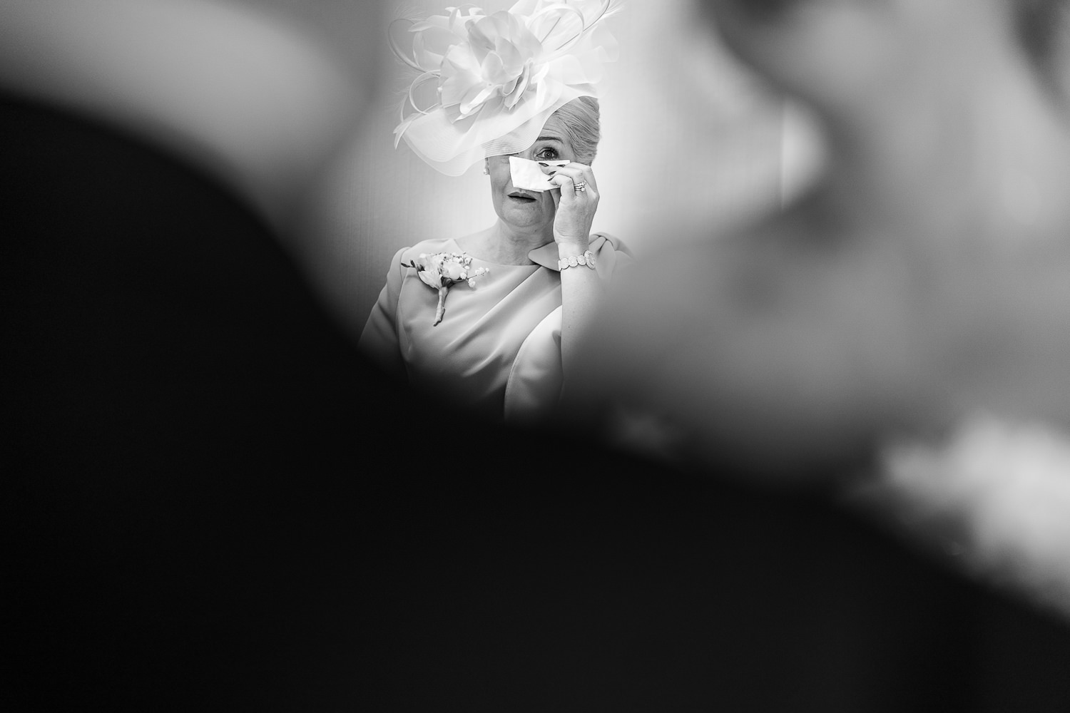 Mother of bride crying looking at bride