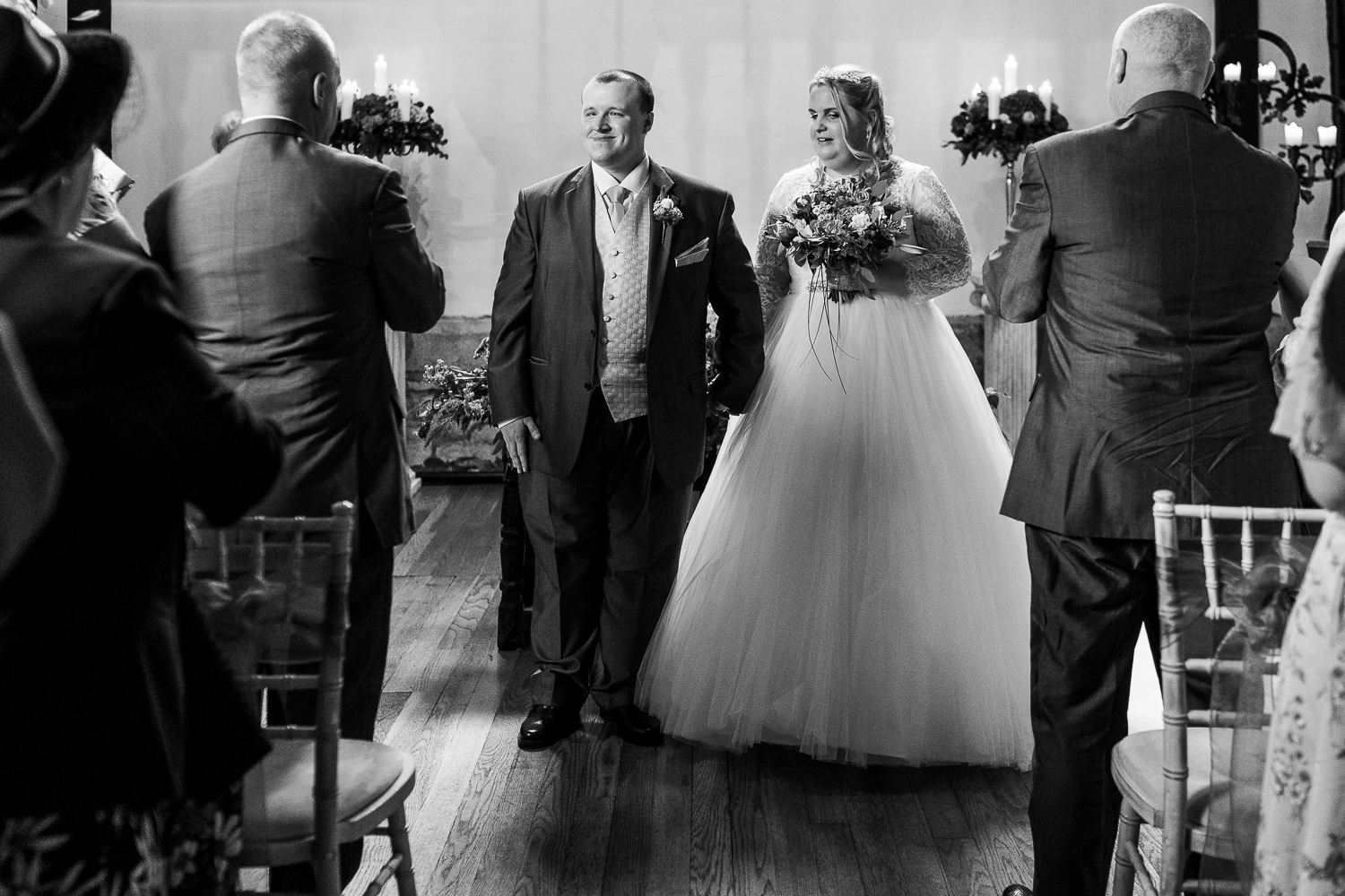 Samlesbury Hall Wedding Photography 10 visually impaired bride and groom walking down the aisle at Samlesbury Hall