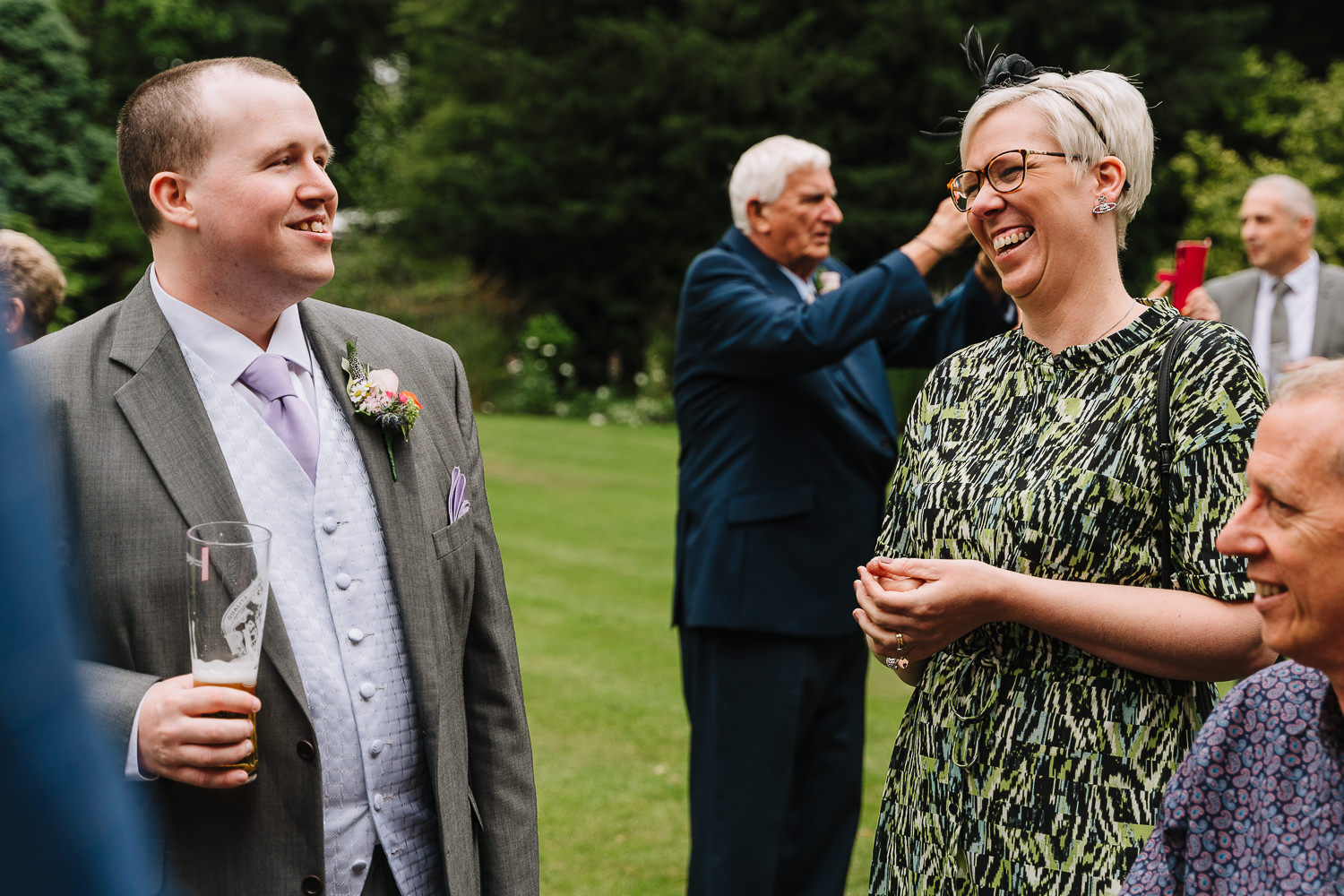 Samlesbury Hall Wedding Photography 13 groom laughing with guests