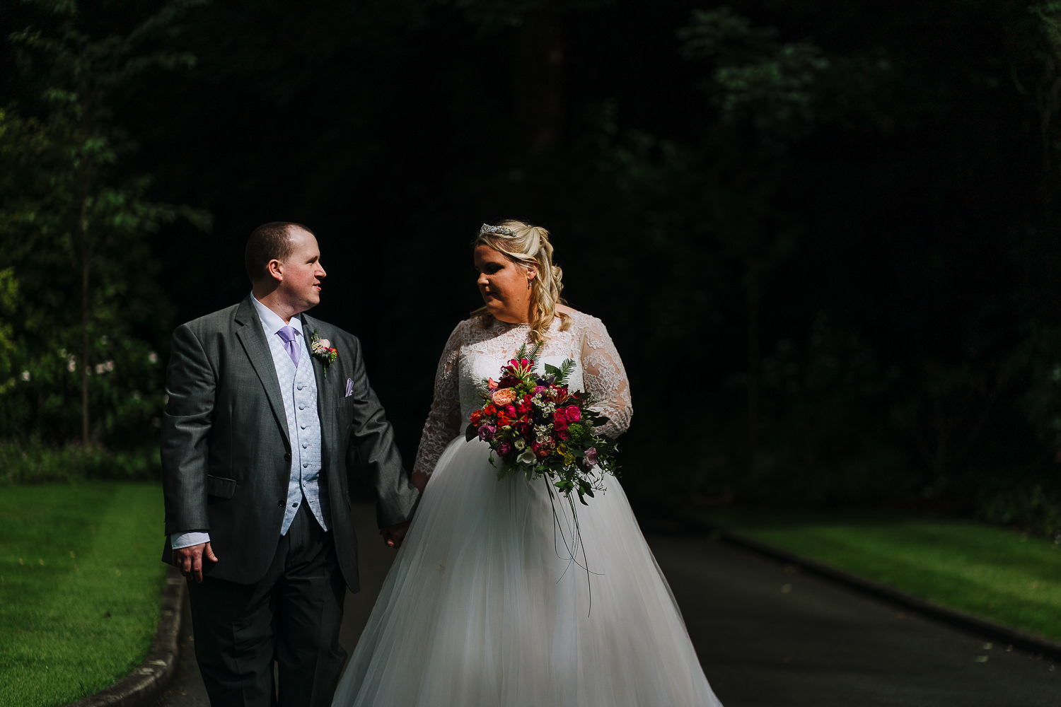 Samlesbury Hall Wedding Photography 16 Bride and groom walking and smiling at Samlesbury Hall