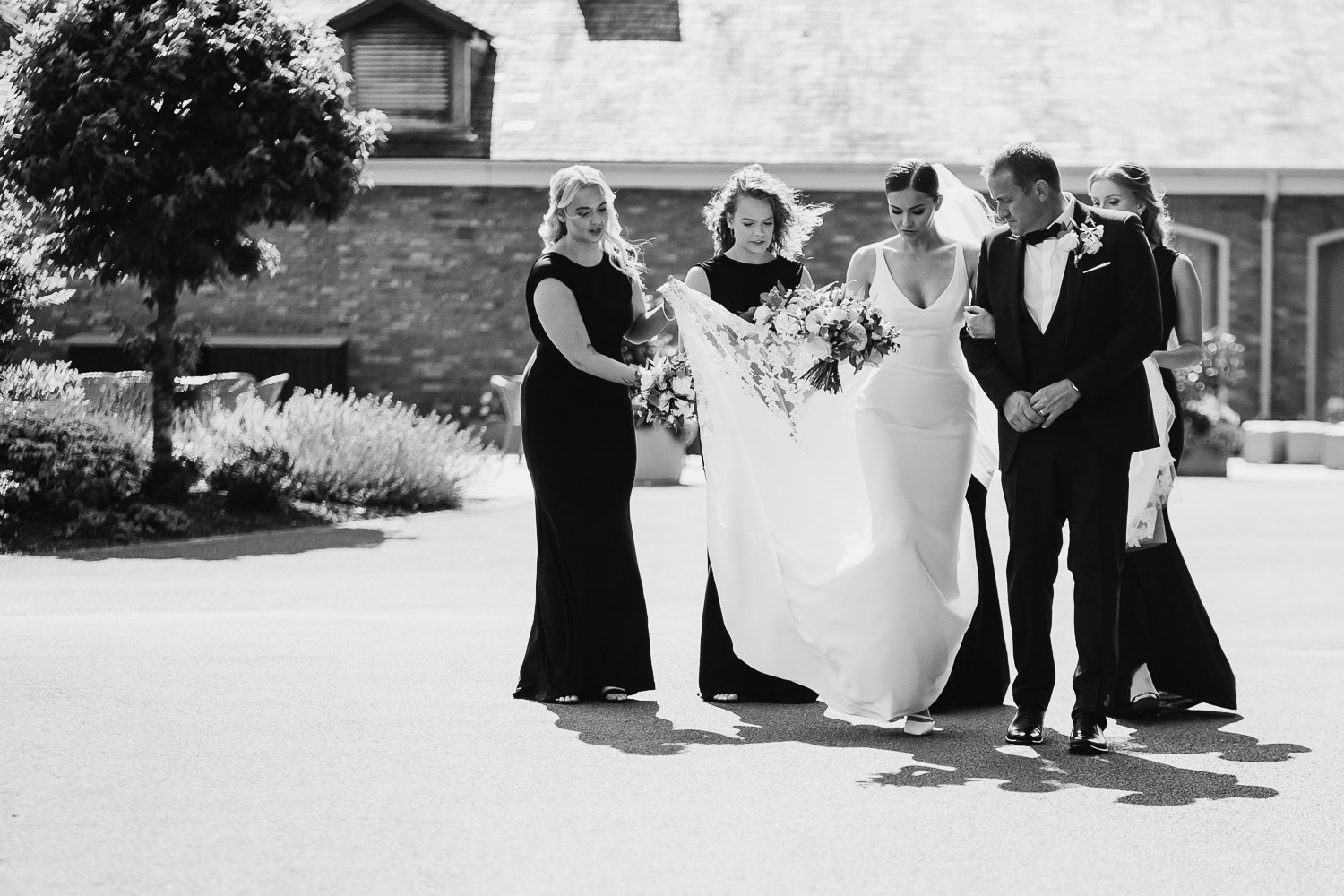 Colshaw Hall Wedding Photos 12 Bride and bridesmaids walking to the ceremony at Colshaw Hall