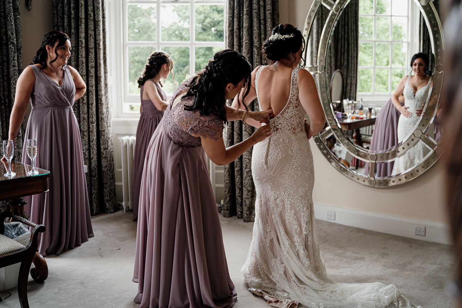 Iscoyd Park Wedding 15 Bride getting into her dress