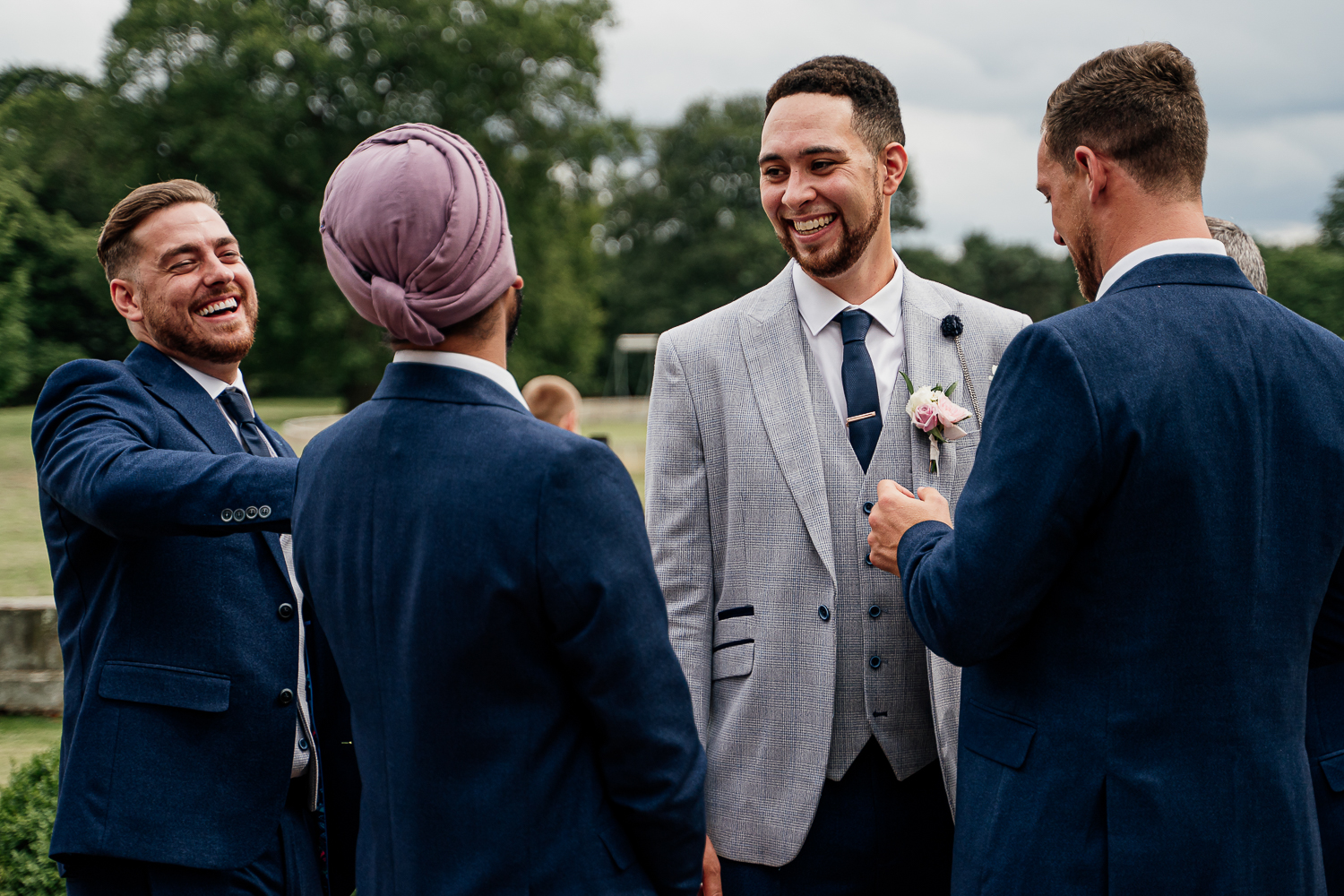Groom laughing with his groomsmen