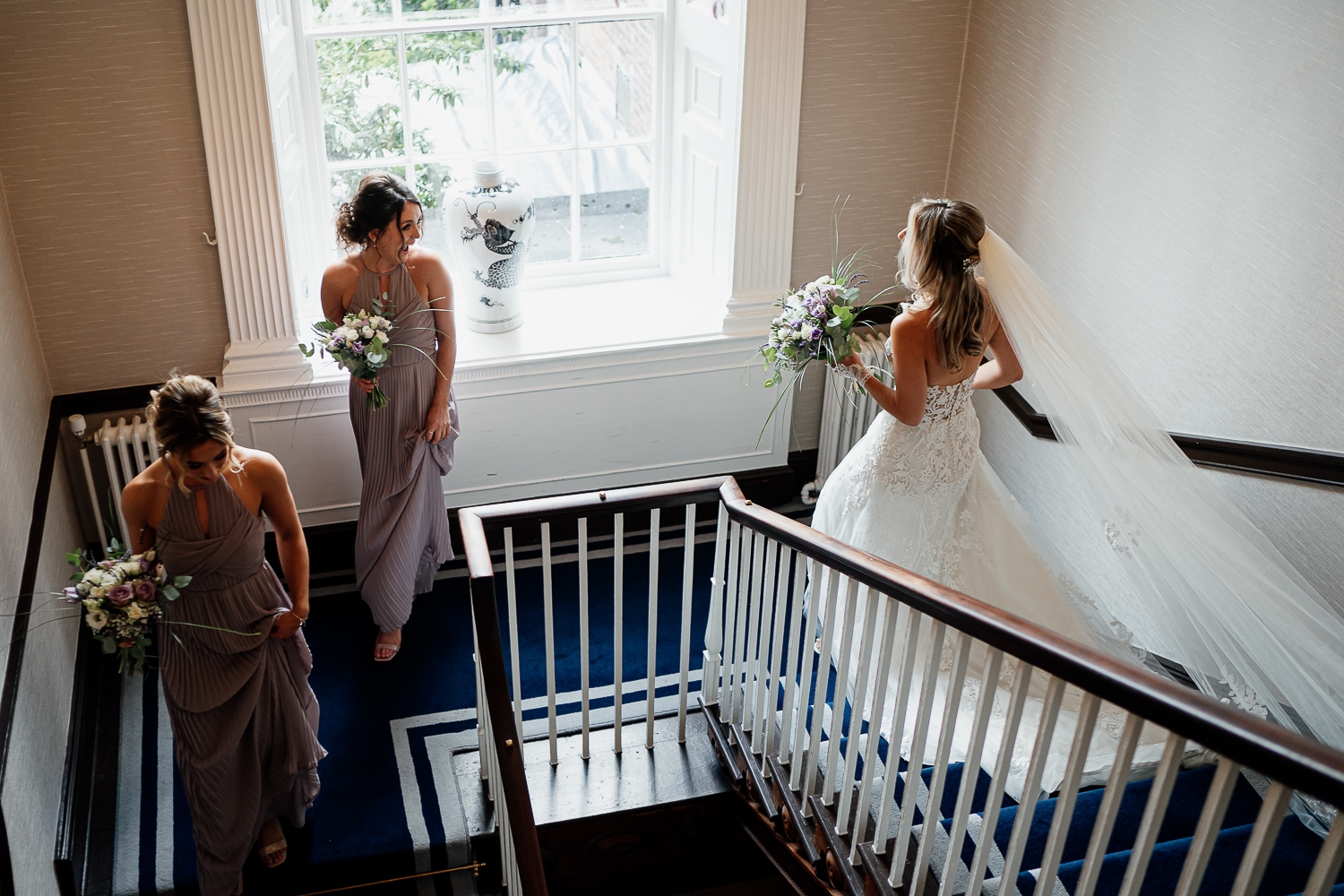 bride walking down the stairs at Mottram Hall