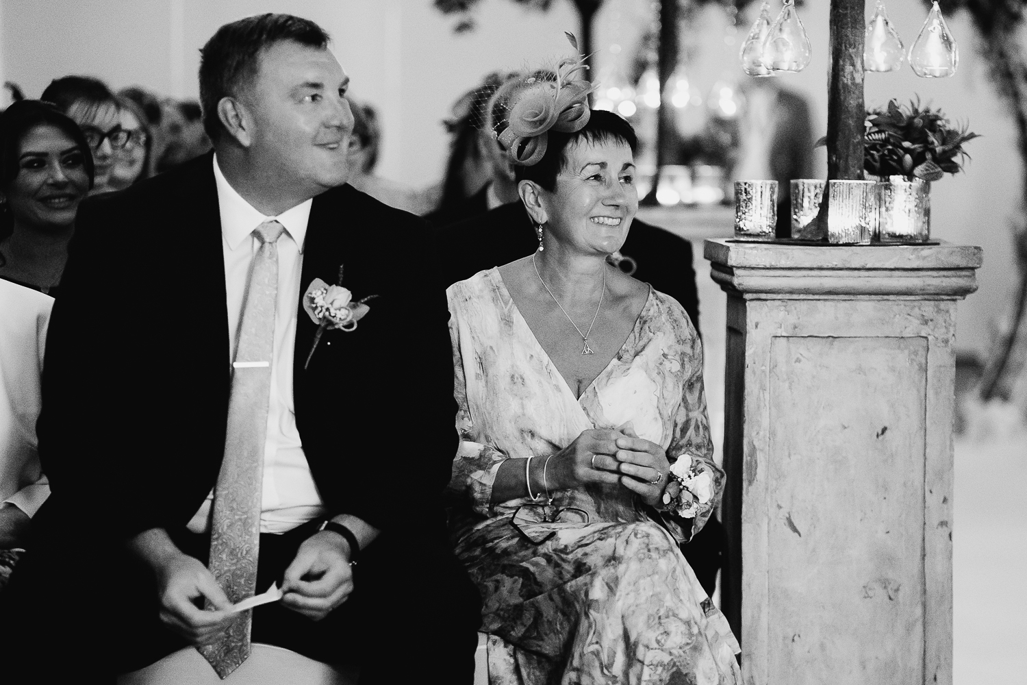 Grooms parents looking on during the service