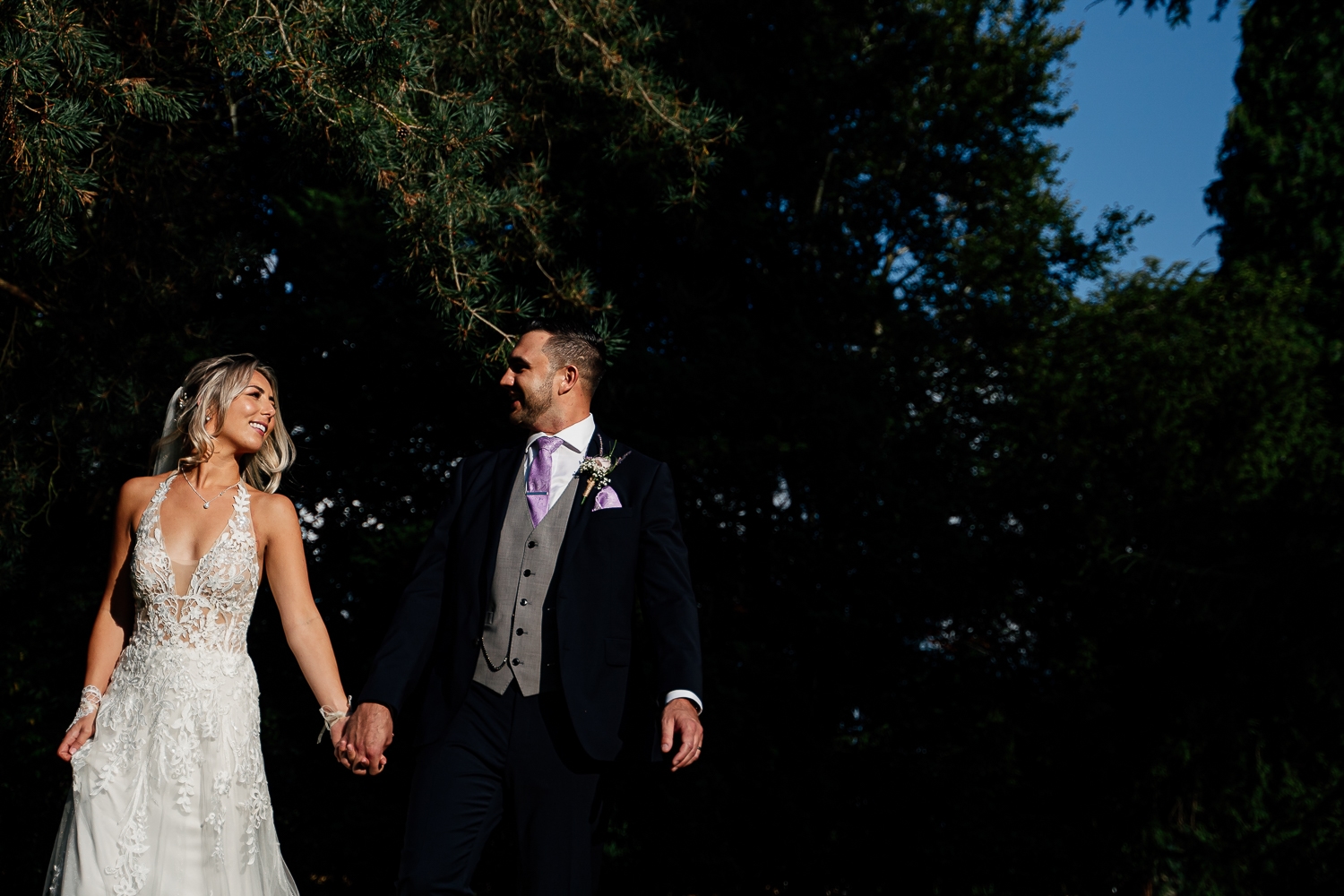 Bride and groom walking at Mottram Hall