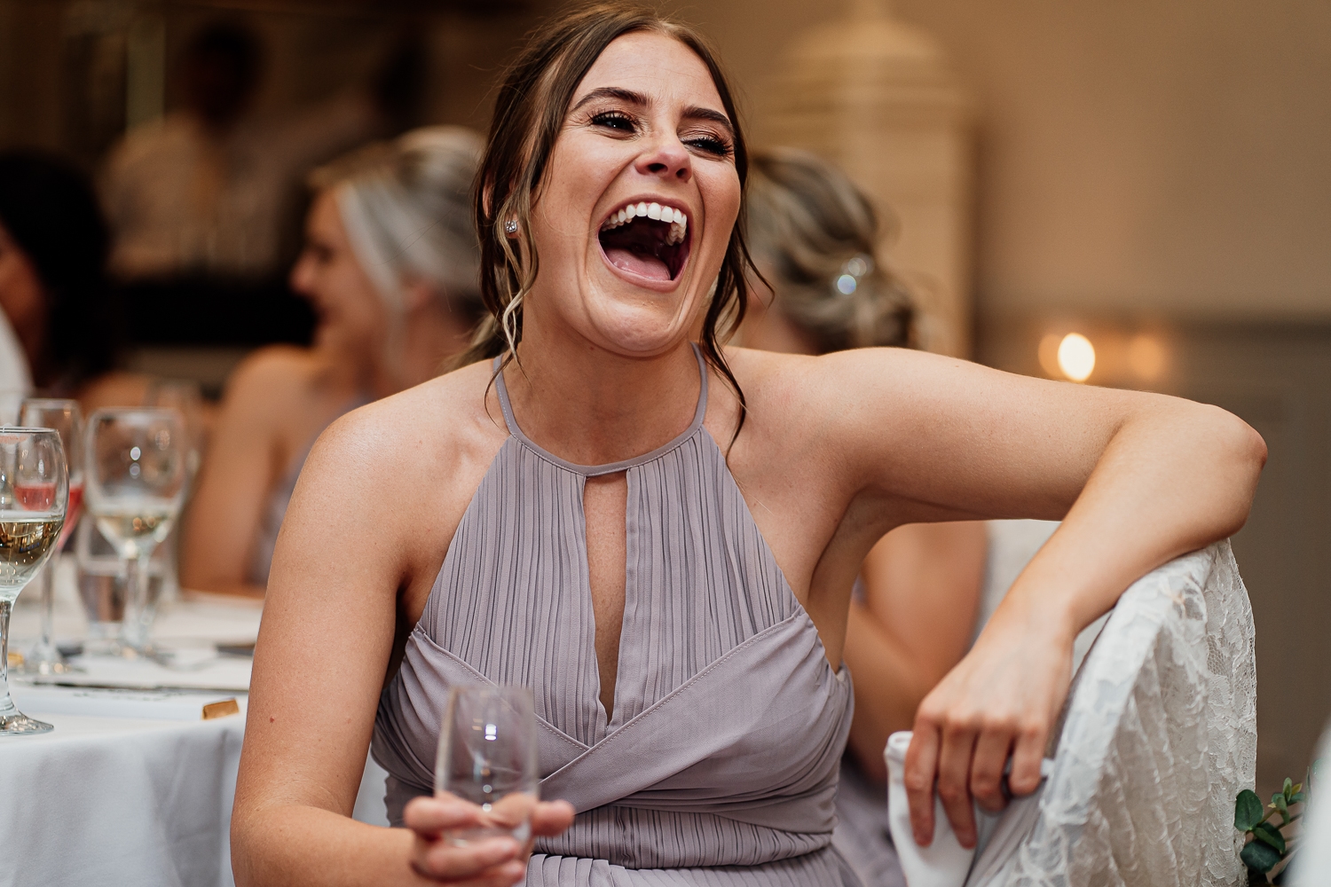 Bridesmaid laughing at Mottram Hall