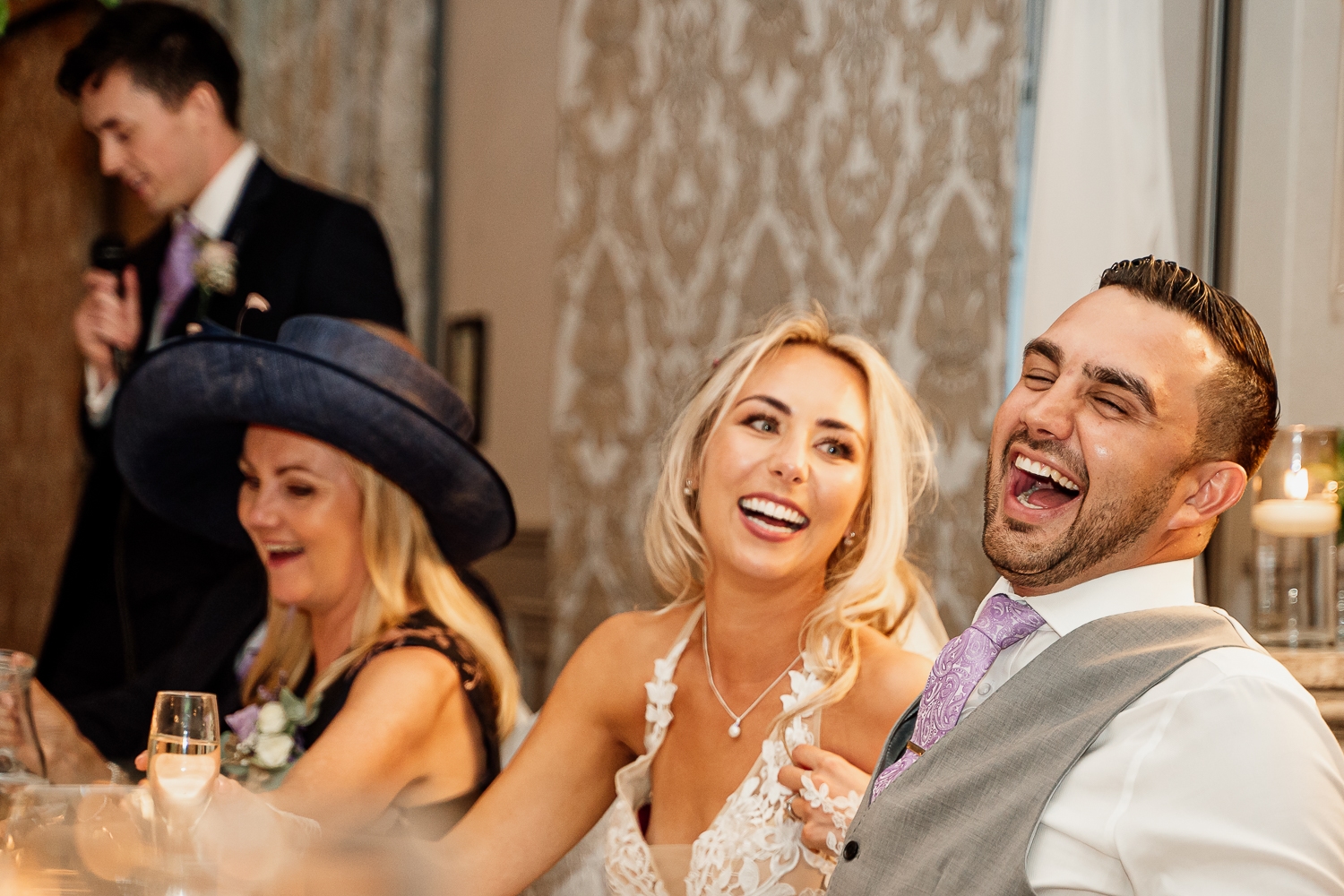 bride and groom laughing during speeches at Mottram Hall